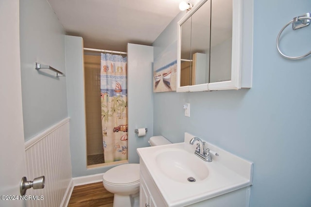 bathroom featuring hardwood / wood-style floors, a shower with curtain, toilet, and vanity