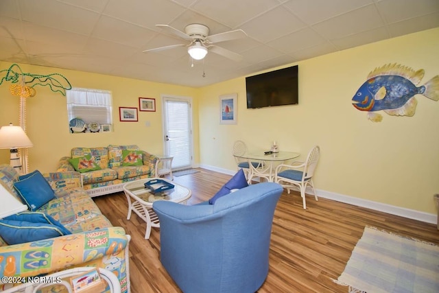 living room featuring ceiling fan and hardwood / wood-style flooring