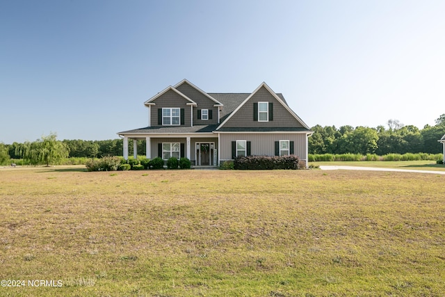 craftsman-style home featuring a front yard and covered porch