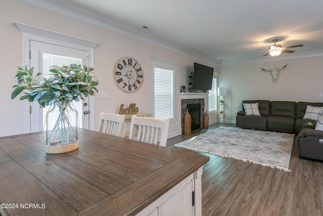 dining room featuring crown molding, ceiling fan, and dark hardwood / wood-style flooring