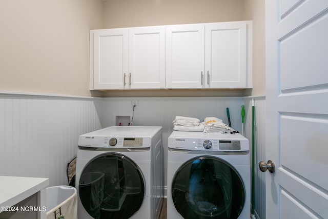 clothes washing area featuring cabinets and washing machine and dryer