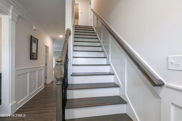 stairway featuring crown molding and hardwood / wood-style flooring