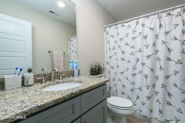 bathroom with vanity, a shower with curtain, and toilet