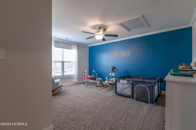 recreation room with crown molding, ceiling fan, and carpet