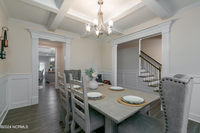 dining room featuring dark hardwood / wood-style floors, a notable chandelier, beam ceiling, and ornate columns