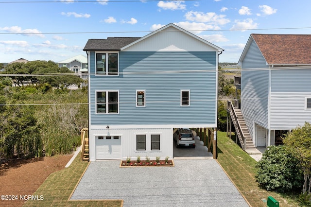 view of front of property with a garage and a carport