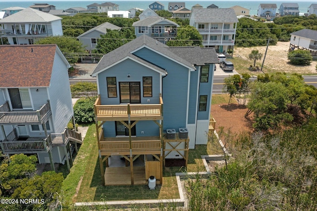 back of property with a balcony and central AC