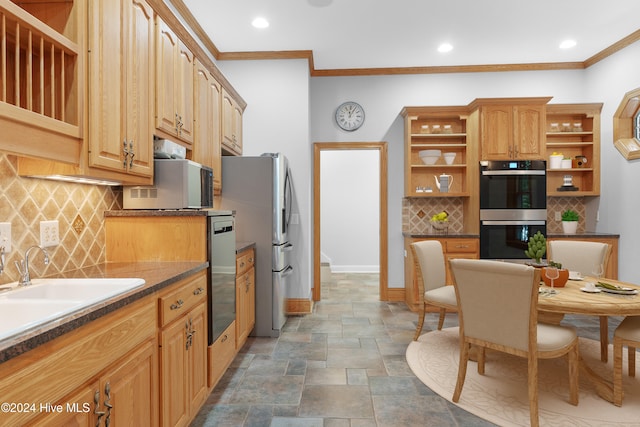 kitchen with ornamental molding, stainless steel appliances, sink, and tasteful backsplash