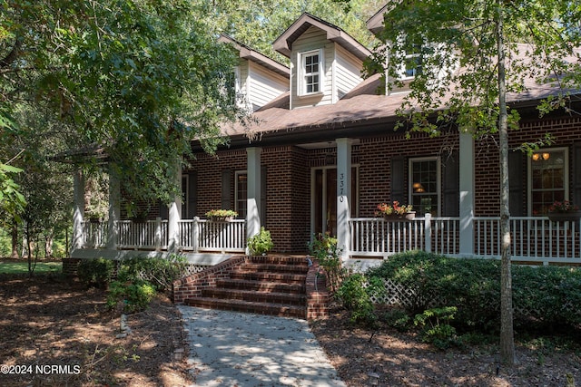 view of front facade featuring a porch and brick siding