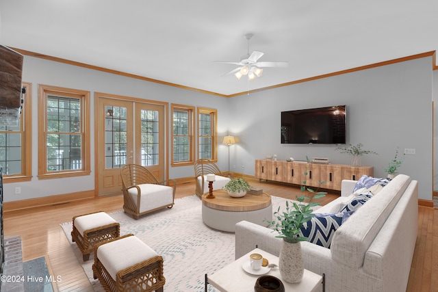 living room featuring ceiling fan, wood-type flooring, and ornamental molding