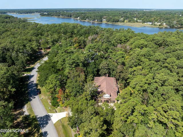 birds eye view of property with a wooded view and a water view