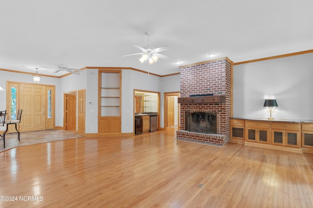 unfurnished living room with a ceiling fan, crown molding, a fireplace, and light wood-type flooring