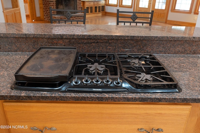 interior details featuring stovetop, baseboards, and dark countertops