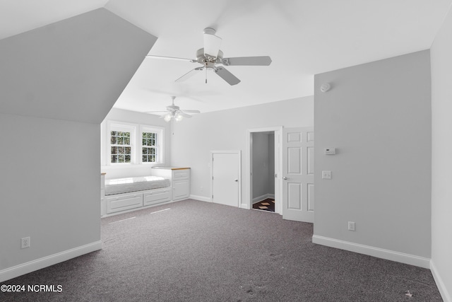 unfurnished bedroom with lofted ceiling, carpet, and baseboards