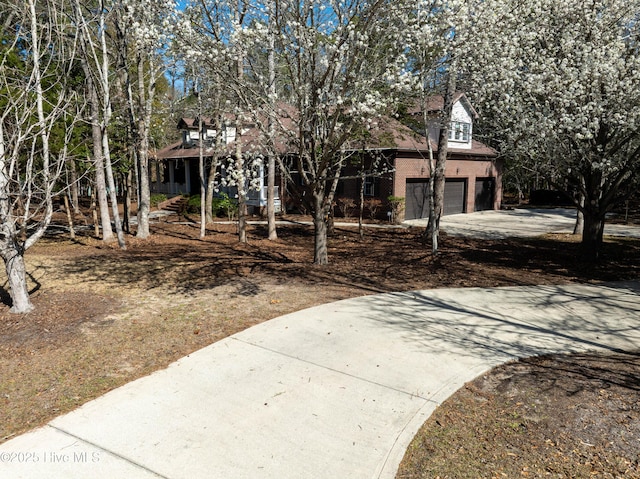 view of front facade featuring brick siding, an attached garage, and concrete driveway