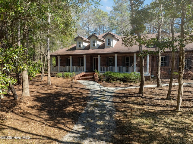 view of front of property with brick siding and covered porch