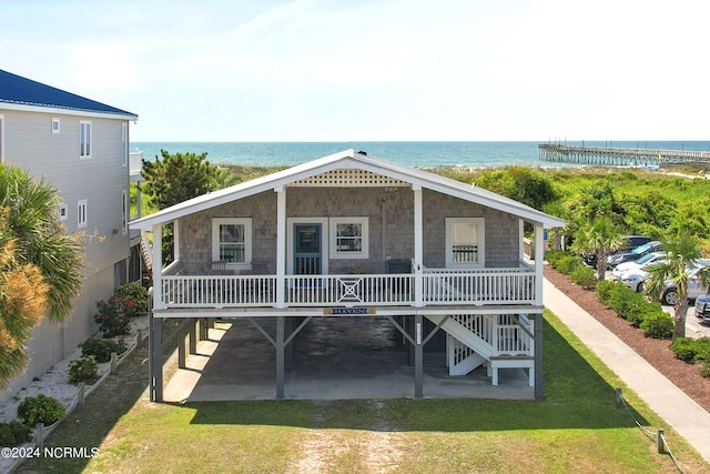 exterior space with a porch and a water view