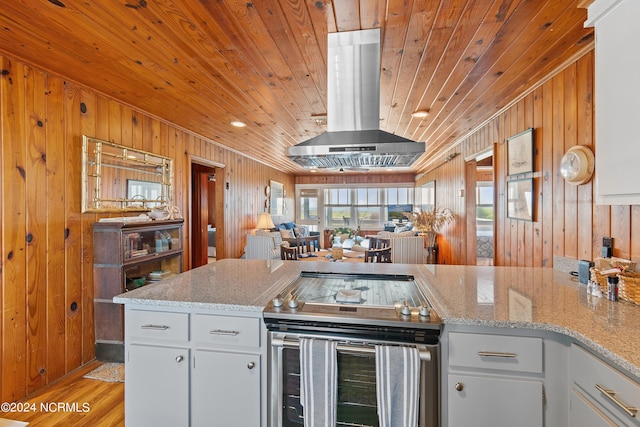 kitchen featuring electric range, wooden ceiling, white cabinets, and island exhaust hood