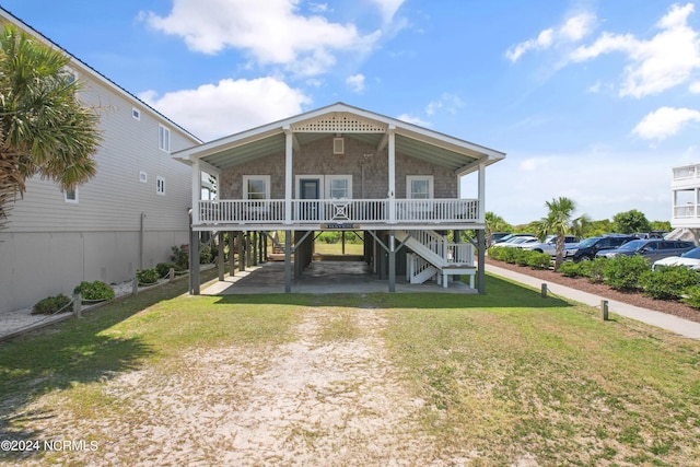 view of front of property with a porch and a front lawn