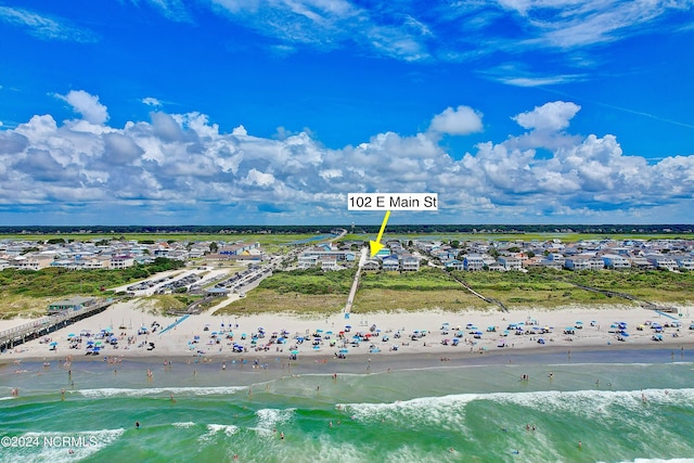 drone / aerial view with a water view and a view of the beach