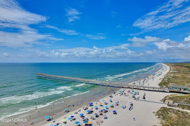 drone / aerial view featuring a water view and a beach view