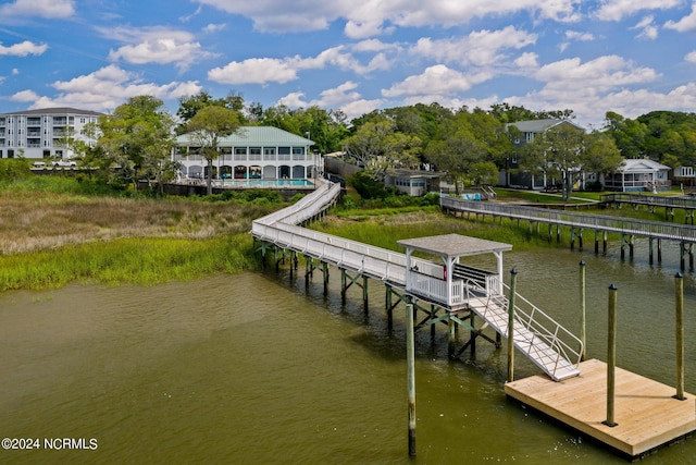 dock area with a pool and a water view