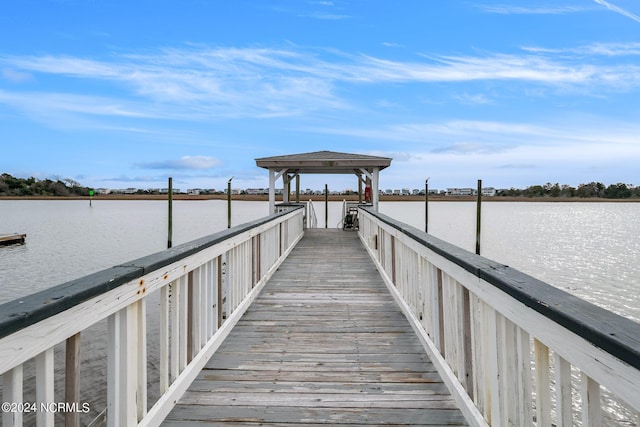 view of dock featuring a gazebo and a water view