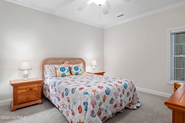 carpeted bedroom with ceiling fan and ornamental molding