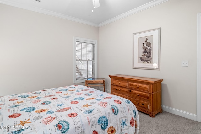 carpeted bedroom with ceiling fan and crown molding