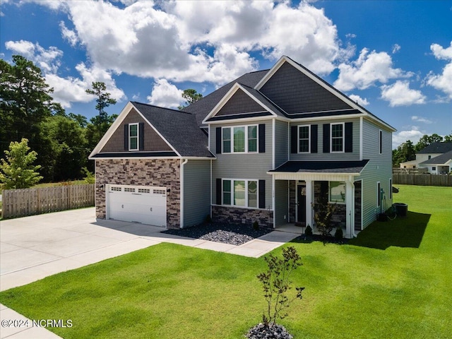 craftsman house with a garage and a front lawn