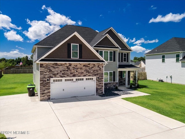 craftsman inspired home featuring a garage and a front lawn