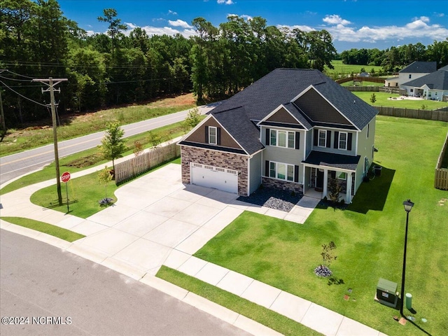 view of front of property featuring a garage and a front yard