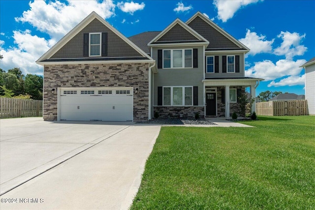 craftsman-style home featuring a garage and a front lawn