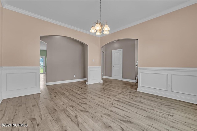 unfurnished dining area with a notable chandelier, hardwood / wood-style floors, and ornamental molding