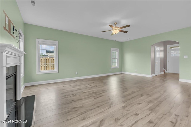 unfurnished living room featuring light hardwood / wood-style flooring and ceiling fan