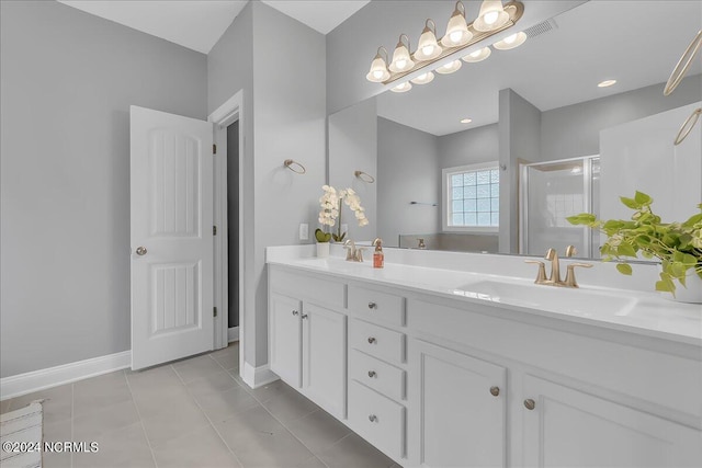 bathroom with a shower with door, double vanity, and tile patterned flooring