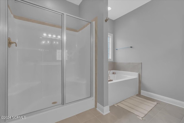 bathroom with separate shower and tub and tile patterned flooring