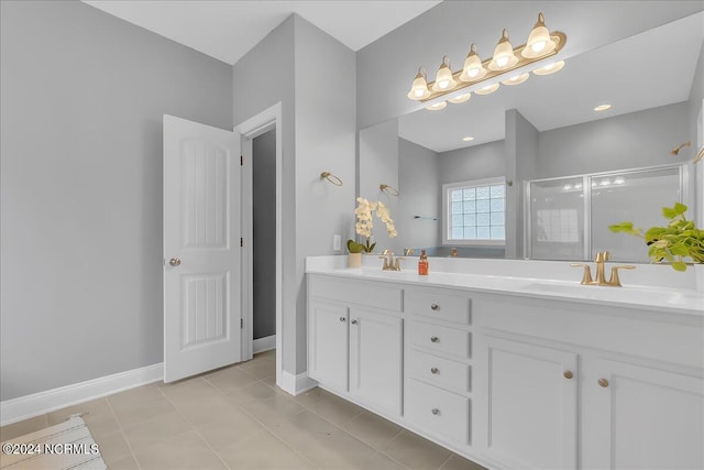 bathroom with double vanity and tile patterned flooring