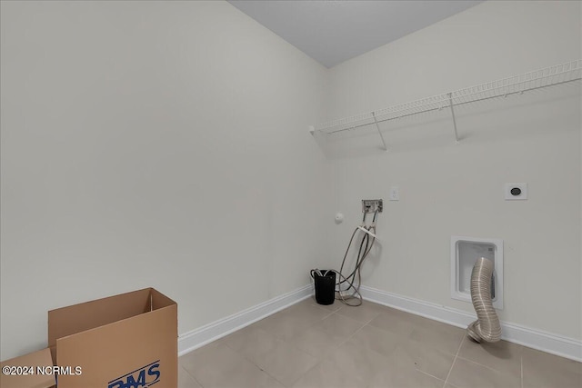 laundry area featuring tile patterned flooring, gas dryer hookup, hookup for an electric dryer, and washer hookup