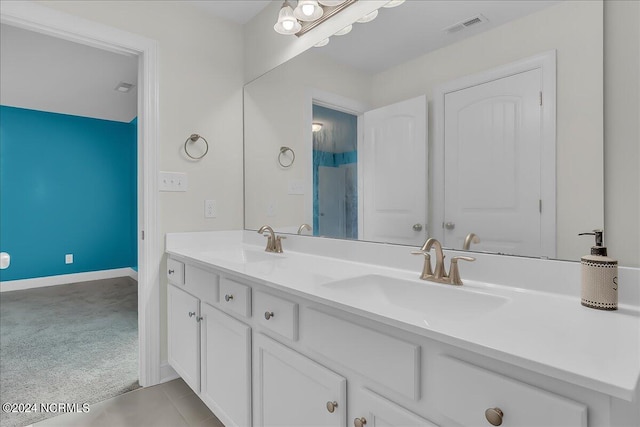 bathroom featuring tile patterned flooring and dual bowl vanity