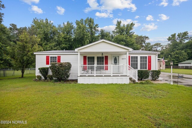 view of front of home with a porch and a front lawn