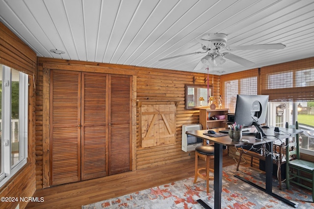 home office featuring rustic walls, wood finished floors, wood ceiling, and heating unit