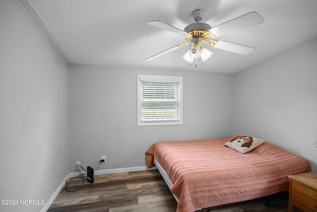 bedroom with ceiling fan, baseboards, and wood finished floors