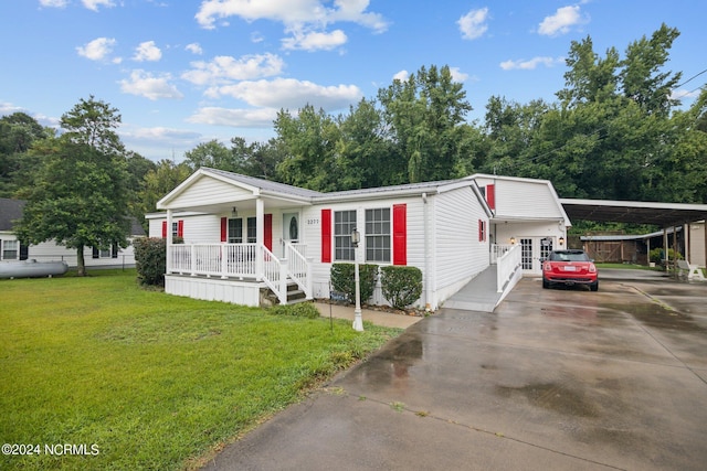 manufactured / mobile home with driveway, french doors, a front lawn, a porch, and a carport