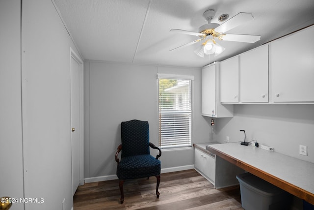 office area with a textured ceiling, light wood finished floors, a ceiling fan, and baseboards