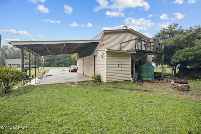 exterior space featuring a fire pit and an attached carport