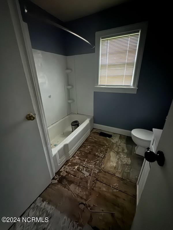 bathroom with washtub / shower combination and toilet