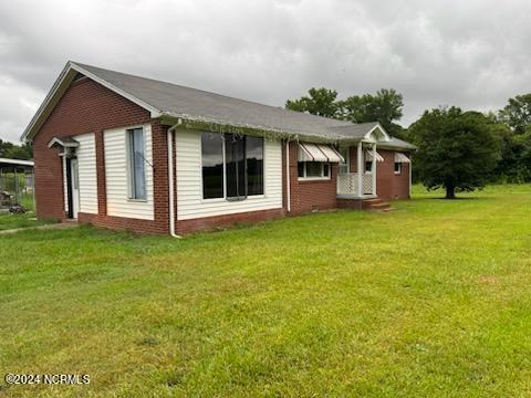 view of home's exterior with a lawn