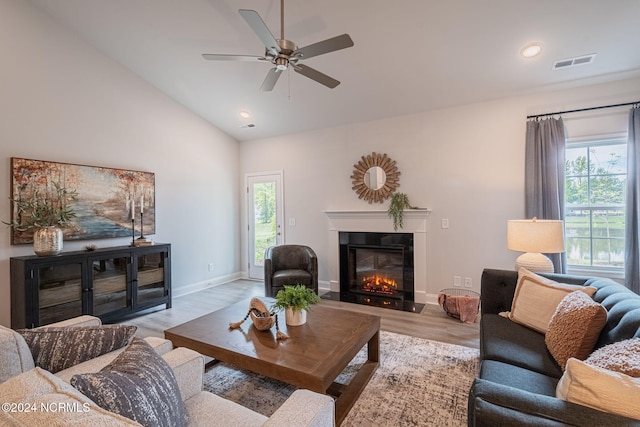 living room featuring high vaulted ceiling, ceiling fan, and light hardwood / wood-style floors