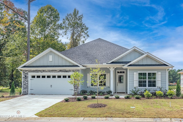 craftsman-style house featuring a front yard and a garage